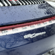 a blue 2023 porsche 911 carrera on a snow-covered road in michigan